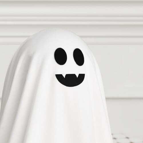 White sheet ghost with smiling face and fangs