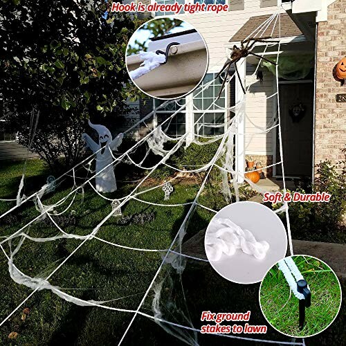 Large outdoor spider web decoration with ghost figure and pumpkins.