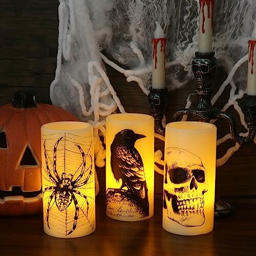 Eldnacele Halloween Flickering Candles with spider, raven, and skull designs next to a carved pumpkin and skull candelabra